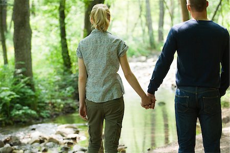 simsearch:633-05401361,k - Couple holding hands, looking at stream running through woods Stock Photo - Premium Royalty-Free, Code: 633-05402137
