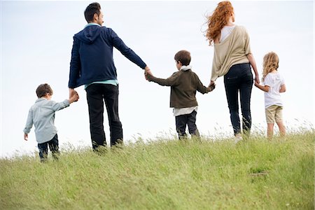 simsearch:633-05402022,k - Family walking hand-in-hand in field, rear view Foto de stock - Royalty Free Premium, Número: 633-05402182