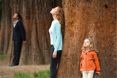 Mother and daughter leaning against tree trunk, breathing fresh air Stock Photo - Premium Royalty-Free, Code: 633-05402183
