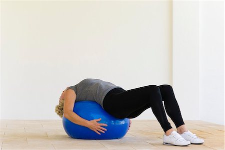 simsearch:633-06354678,k - Woman lying on fitness ball Stock Photo - Premium Royalty-Free, Code: 633-06322198