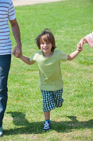 simsearch:633-05401448,k - Boy walking hand in hand with parents outdoors, cropped Stock Photo - Premium Royalty-Free, Code: 633-06322583