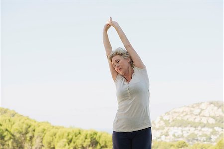 Mature woman stretching arms Stock Photo - Premium Royalty-Free, Code: 633-06354678