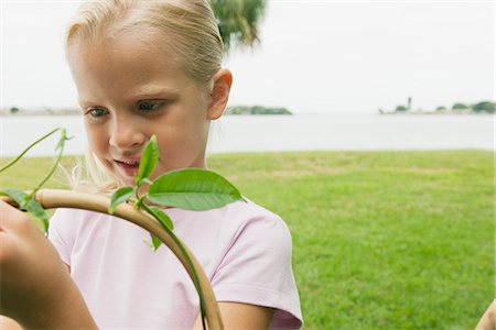 stake - Girl wrapping vine around stake in garden Stock Photo - Premium Royalty-Free, Code: 633-06354671