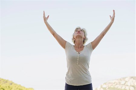 simsearch:633-06354678,k - Mature woman doing sun salutation Stock Photo - Premium Royalty-Free, Code: 633-06354762