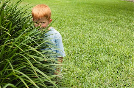 simsearch:632-05845347,k - Boy hiding behind tall grass Stock Photo - Premium Royalty-Free, Code: 633-06355057