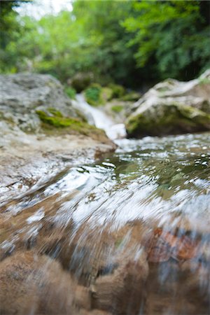 streaming (flow of movement) - Water flowing over rocks, close-up Stock Photo - Premium Royalty-Free, Code: 633-06406425