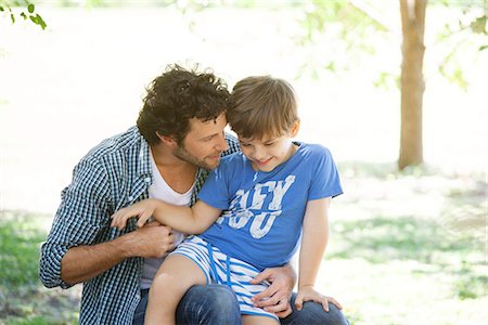 simsearch:632-03848313,k - Boy sitting on father's lap Stock Photo - Premium Royalty-Free, Code: 633-08150919