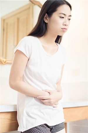 simsearch:695-05764382,k - Woman suffering from stomach pain Stock Photo - Premium Royalty-Free, Code: 633-08482172