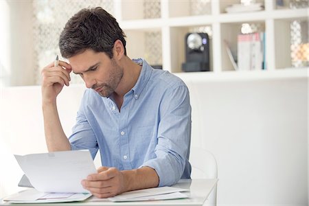 read at home - Man frustrated by mounting debt Stock Photo - Premium Royalty-Free, Code: 633-08638873