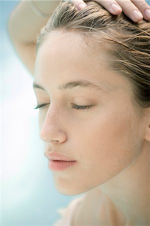 pool wet - Young woman with hand on head, eyes closed, portrait Stock Photo - Premium Royalty-Free, Code: 633-08639091