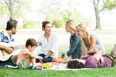 father playing guitar - Friends enjoying picnic in park Stock Photo - Premium Royalty-Free, Code: 633-08726261