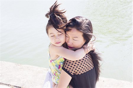 simsearch:632-02416107,k - Mother and daughter embracing outdoors Stock Photo - Premium Royalty-Free, Code: 633-08726370