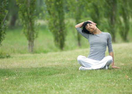 simsearch:695-03373919,k - Young woman stretching on grass Stock Photo - Premium Royalty-Free, Code: 633-01274040