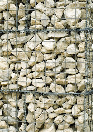 Stone wall contained by wire mesh, close-up Fotografie stock - Premium Royalty-Free, Codice: 633-01274167