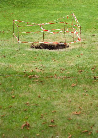 simsearch:6118-09059537,k - Hole in grass, roped off with barrier Stock Photo - Premium Royalty-Free, Code: 633-01274372