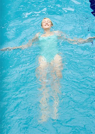 simsearch:633-01573892,k - Young woman floating on back in pool Stock Photo - Premium Royalty-Free, Code: 633-01274832