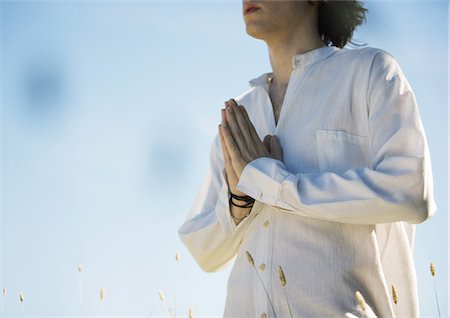 simsearch:632-03651843,k - Man standing with hands in prayer, mid section Stock Photo - Premium Royalty-Free, Code: 633-01274960