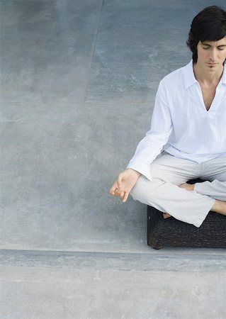 Man meditating, partial view Stock Photo - Premium Royalty-Free, Code: 633-01275056