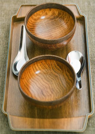 Two wooden bowls and metal spoons on wooden tray Stock Photo - Premium Royalty-Free, Code: 633-01272149