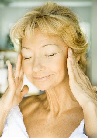 Senior woman with hands on side of face and eyes shut Stock Photo - Premium Royalty-Free, Code: 633-01272172