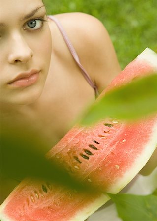 simsearch:633-01573481,k - Young woman holding up slice of watermelon Stock Photo - Premium Royalty-Free, Code: 633-01272286