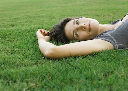 simsearch:632-01149081,k - Woman lying in grass Stock Photo - Premium Royalty-Free, Code: 633-01272325