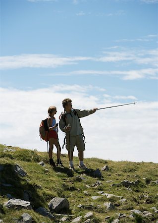 Hikers, man pointing with walking stick Stock Photo - Premium Royalty-Free, Code: 633-01272422