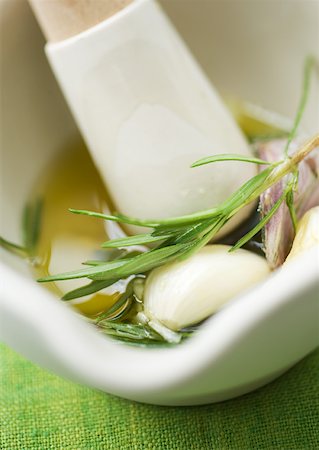 Mortar and pestle with herbs, olive oil and garlic Stock Photo - Premium Royalty-Free, Code: 633-01272487