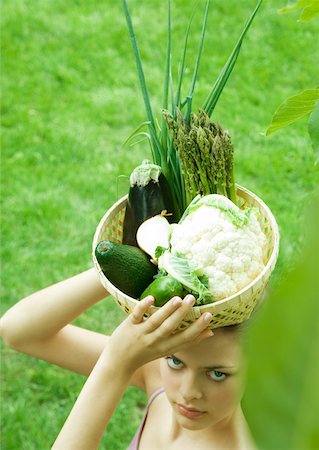 simsearch:633-01272776,k - Woman holding basket full of fresh vegetables on top of head Foto de stock - Royalty Free Premium, Número: 633-01272752