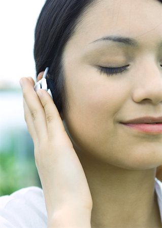 simsearch:633-02128680,k - Woman listening to earphones Stock Photo - Premium Royalty-Free, Code: 633-01272760