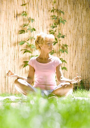 senior woman meditating - Senior woman doing yoga outdoors Stock Photo - Premium Royalty-Free, Code: 633-01272815