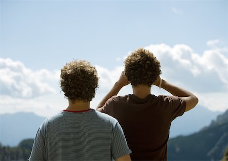 Two young men looking at mountain view with binoculars, rear view Stock Photo - Premium Royalty-Free, Code: 633-01273033