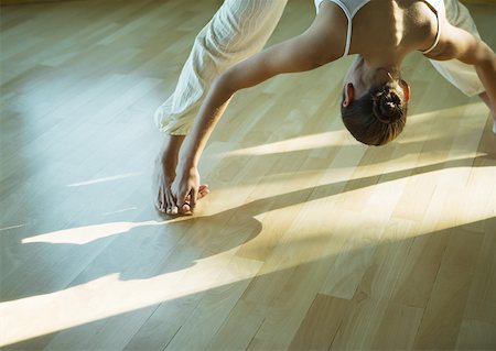 Yoga class, woman doing yoga pose (prasarita padottanasana) Stock Photo - Premium Royalty-Free, Code: 633-01273121