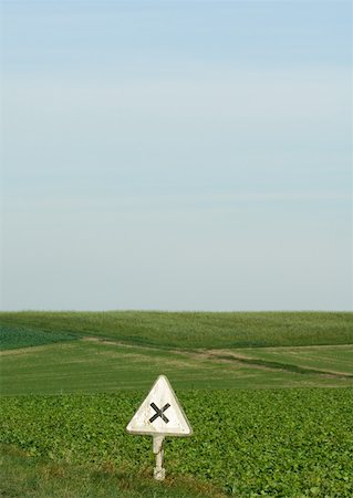 road sign animals - Warning sign and field of crops Stock Photo - Premium Royalty-Free, Code: 633-01273277