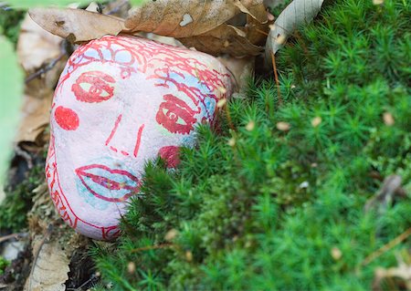 draw close up face - Stone decorated with face, lying on ground Stock Photo - Premium Royalty-Free, Code: 633-01273302
