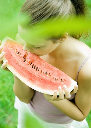 Woman holding slice of watermelon Stock Photo - Premium Royalty-Free, Code: 633-01273396