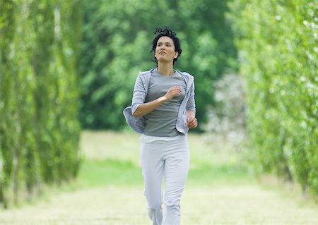 simsearch:633-01714388,k - Young woman jogging outdoors Foto de stock - Sin royalties Premium, Código: 633-01273400