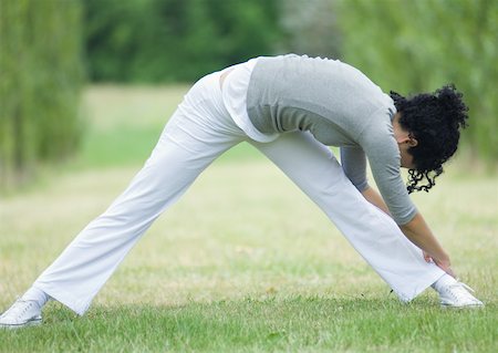 simsearch:695-03373919,k - Young woman stretching, outdoors Stock Photo - Premium Royalty-Free, Code: 633-01273500