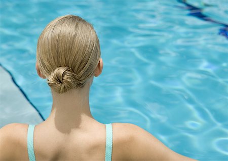 Young woman, rear view of head and shoulders, pool in background Stock Photo - Premium Royalty-Free, Code: 633-01273523