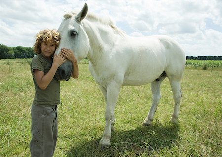 simsearch:633-01272720,k - Boy standing cheek to cheek with horse Stock Photo - Premium Royalty-Free, Code: 633-01273634