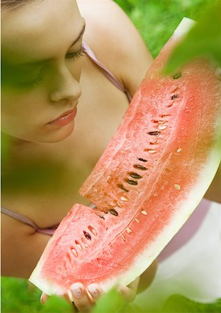 Woman holding slice of watermelon Stock Photo - Premium Royalty-Free, Code: 633-01273752