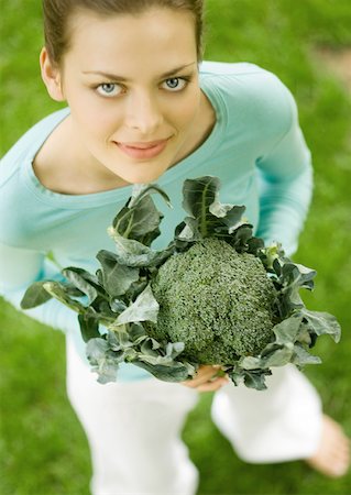 people holding broccoli - Young woman holding up broccoli Stock Photo - Premium Royalty-Free, Code: 633-01273879