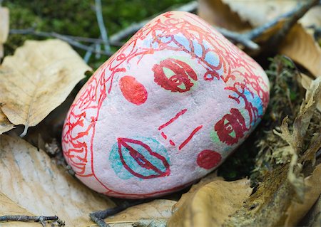 draw close up face - Stone decorated with face, lying on ground Stock Photo - Premium Royalty-Free, Code: 633-01273961