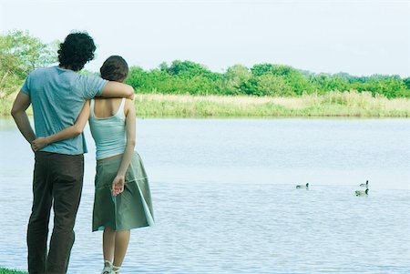 simsearch:696-03402108,k - Couple standing by lake, looking at view, rear view Stock Photo - Premium Royalty-Free, Code: 633-01574050