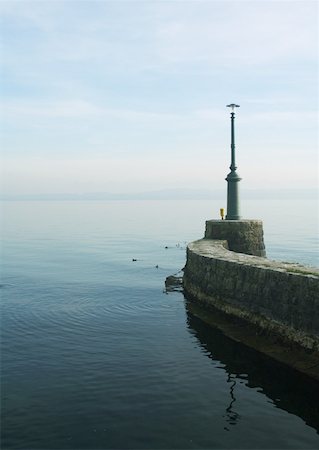 simsearch:633-01574131,k - Stone breakwater with beacon Fotografie stock - Premium Royalty-Free, Codice: 633-01574117