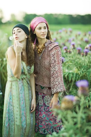 dress blowing - Young hippie women standing in field, one blowing dandelion seeds Stock Photo - Premium Royalty-Free, Code: 633-01574159