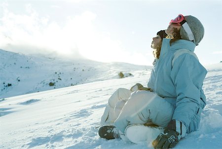 simsearch:6118-07966899,k - Teen girls sitting in snow with heads back and eyes closed Stock Photo - Premium Royalty-Free, Code: 633-01574564