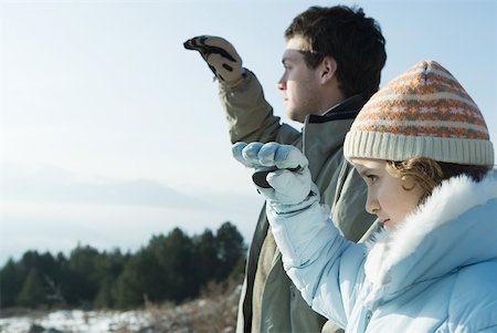 simsearch:632-03424260,k - Young man and girl standing in snowy landscape, looking toward distance Stock Photo - Premium Royalty-Free, Code: 633-01574571