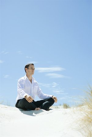 Man sitting indian style on dune Stock Photo - Premium Royalty-Free, Code: 633-01574586