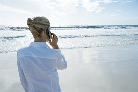simsearch:633-01574593,k - Businesswoman using cell phone on beach, rear view Stock Photo - Premium Royalty-Free, Code: 633-01574627